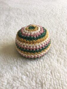 striped desert crocheted hacky sack pink green mustard cream